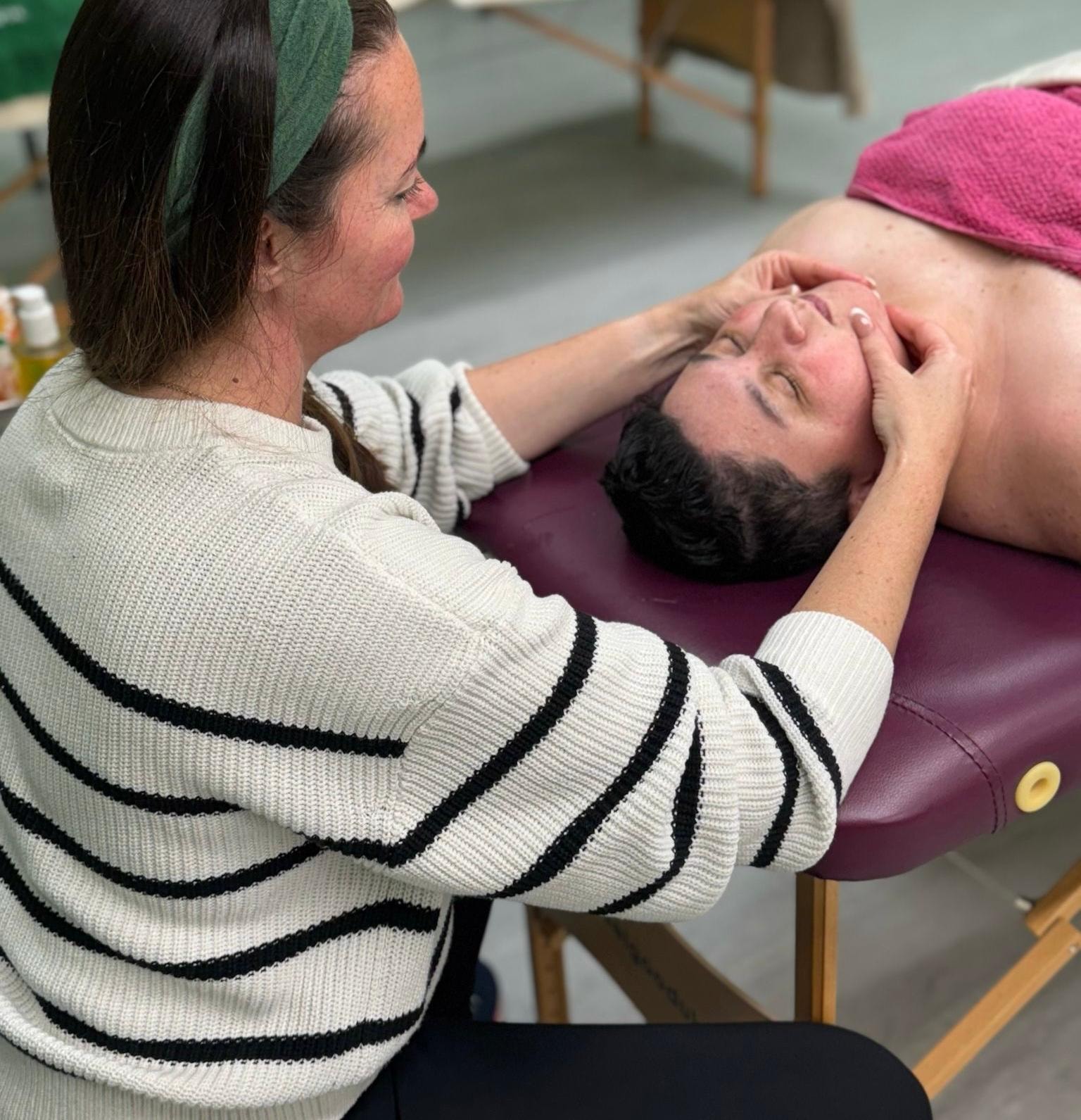 Mandie Pirie performing a holistic facial treatment on a client